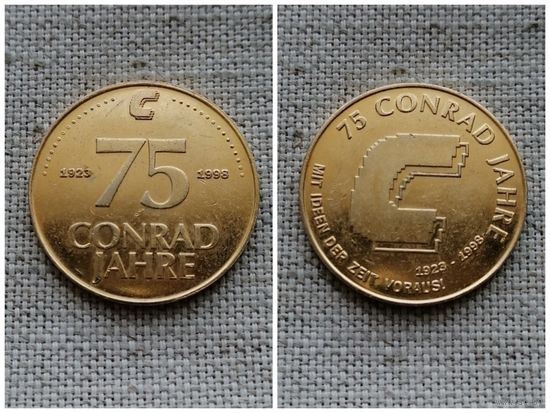 Жетон рекламный Германия / 1998 г.. 75 лет компании Конрад Джахре (30,1 мм.,7,7 гр..)